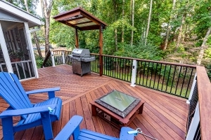Cumaru 1x6 hardwood deck with diagonal board pattern, black metal railing, pergola, and outdoor living space