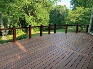 Cumaru decking grooved for hidden clip fasteners, showing clean board spacing, smooth surface, and rich natural hardwood tones