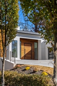 Garapa Rainscreen Siding Exterior Front Door Garapa hardwood rainscreen siding installed on a modern exterior front door with horizontal wood planks and contemporary architecture