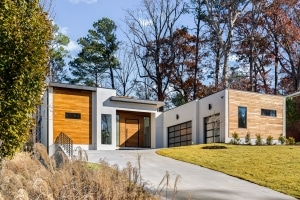 Garapa Rainscreen Siding on Modern Home in Brookhaven GA Modern Brookhaven, GA home with garapa rainscreen siding, white stucco walls, flat rooflines, and contemporary glass garage doors.