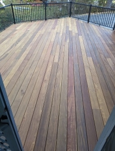 Cumaru 1x6 grooved decking three weeks after oiling, showing natural color variation and clean surface from hidden fasteners