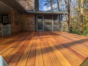 Freshly oiled Cumaru 1x6 grooved decking with rich color variation, installed using hidden fasteners on an exterior deck