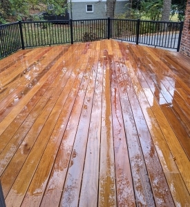 Cumaru 1x6 grooved decking after rain, showing rich natural color, tight grain, and hidden fastener installation