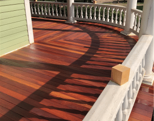 Cumaru 3.5 inch tongue and groove porch decking installed on curved wraparound porch with rich red brown Brazilian hardwood tones