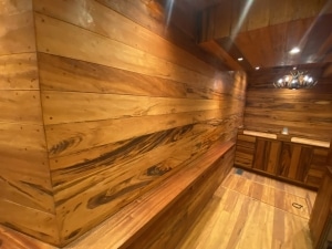 Tigerwood 5-inch T&G accent wall paneling inside a Sandy Springs GA gun room.