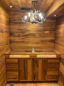 Interior gun room finished with Tigerwood 5-inch T&G wall boards and cabinetry in Sandy Springs GA.