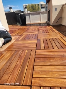 Rooftop patio with freshly oiled Cumaru deck tiles in warm Brazilian hardwood colors