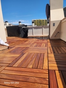 Rooftop patio with interlocking Cumaru deck tiles in warm Brazilian hardwood colors