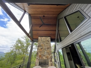 Brown Balau 5” Tongue and Groove Vaulted Exterior Ceiling Brown Balau 5-inch tongue and groove vaulted ceiling installed on covered patio with exposed beams and outdoor fireplace
