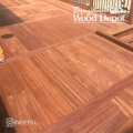 Cumaru hardwood deck with picture-frame border design showing warm red-gold grain variation.