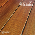 Close-up of Ipe 5/4×4 decking boards showing smooth grain and rich brown color for premium ipe hardwood decking.
