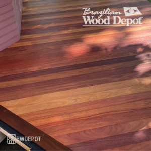 Cumaru T&G porch floor showing warm red, amber, and brown color variation in natural hardwood grain.