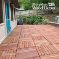 Patio installation featuring multiple Cumaru deck tiles arranged in alternating directions for a patterned layout.