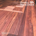 Close-up of Cumaru hardwood decking showing bold grain patterns and deep red-brown color variations.