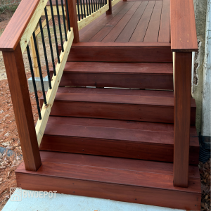 Massaranduba decking 1x6 boards installed on exterior stairs with matching risers and black metal railing.