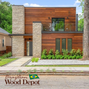 Two-story modern home featuring horizontal Ipe RainScreen siding paired with light stone columns and landscaping.
