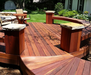 Cumaru Red decking boards installed on a residential deck, showing deep red and rich brown tones with consistent coloration.