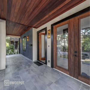 Exterior entry area with Tigerwood soffit/ceiling boards above a porch and matching wood door tones.