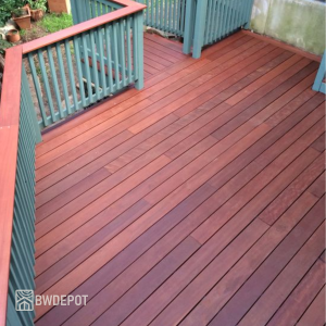 Backyard deck built with Massaranduba decking 1x6 boards and green painted railing.