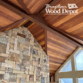 Garapa soffit and tongue and groove ceiling installation in vaulted outdoor patio with stone wall
