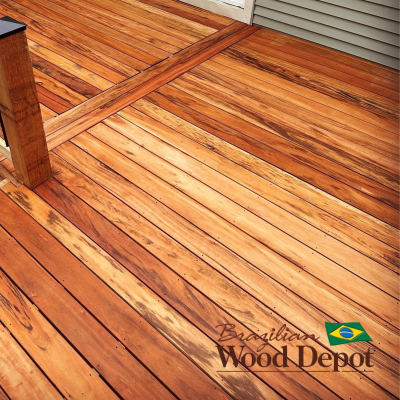 Tigerwood hardwood decking boards with bold striped grain pattern in golden and reddish brown tones