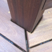 Close-up of Ipe decking boards with eased rounded ends and clean spacing around a deck post detail on BWDepot.com