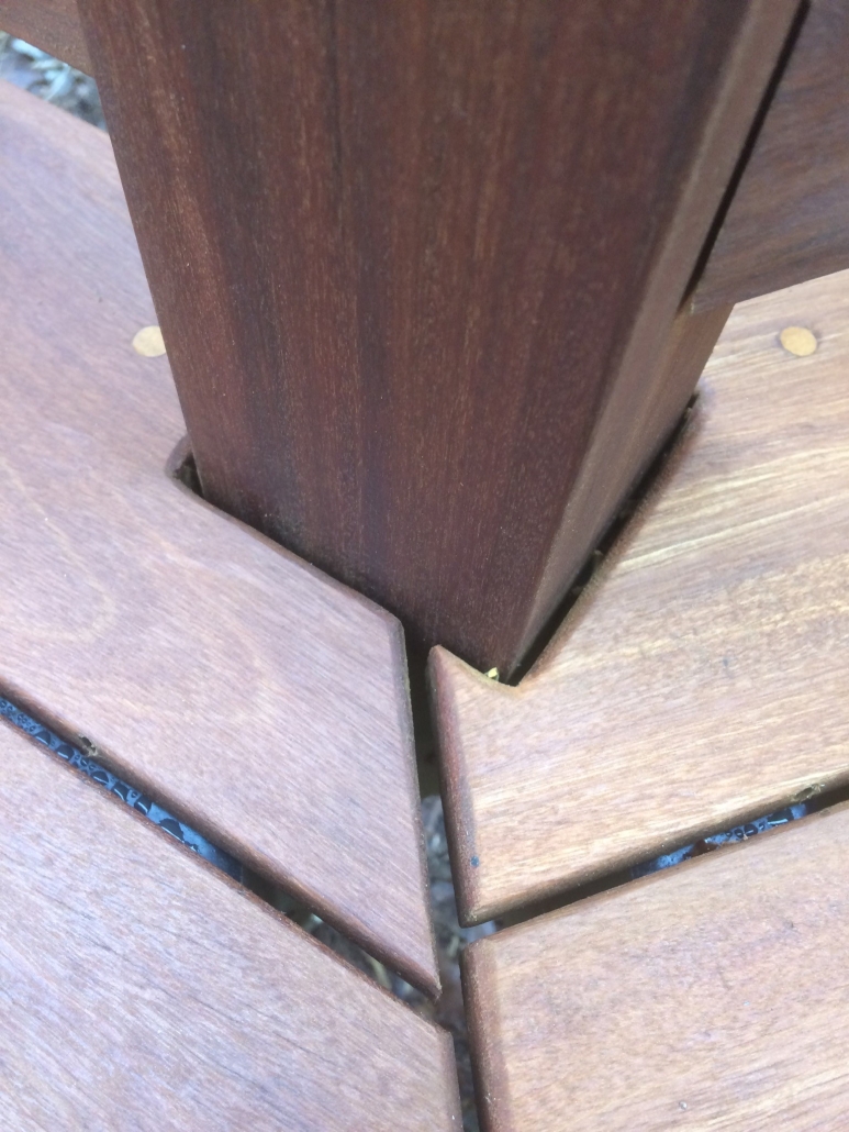 Close-up of Ipe decking boards with eased rounded ends and clean spacing around a deck post detail on BWDepot.com