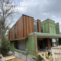 Contemporary home under construction with Brown Balau RainScreen siding