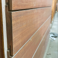 Close-up of Massaranduba RainScreen Siding from Brazilian Wood Depot showing concealed aluminum clip installation and clean shadow lines.